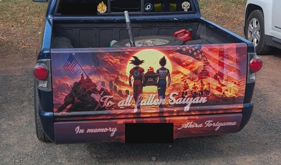 Custom painted car trunk with soldiers, flags, and sunset scene, in memory of Ahera Toriyama.