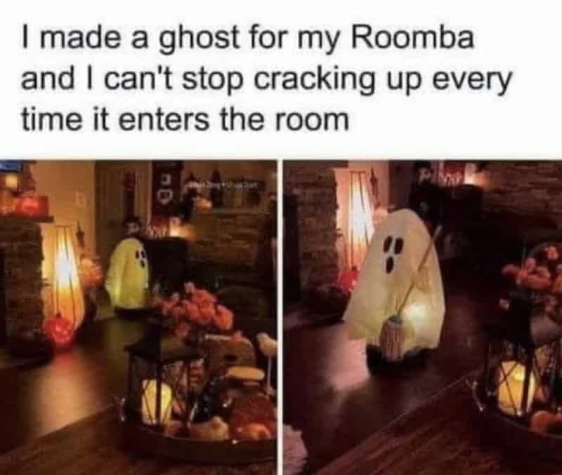 Ghost decoration on a table with flowers and lanterns, caption about making a ghost for Roomba.