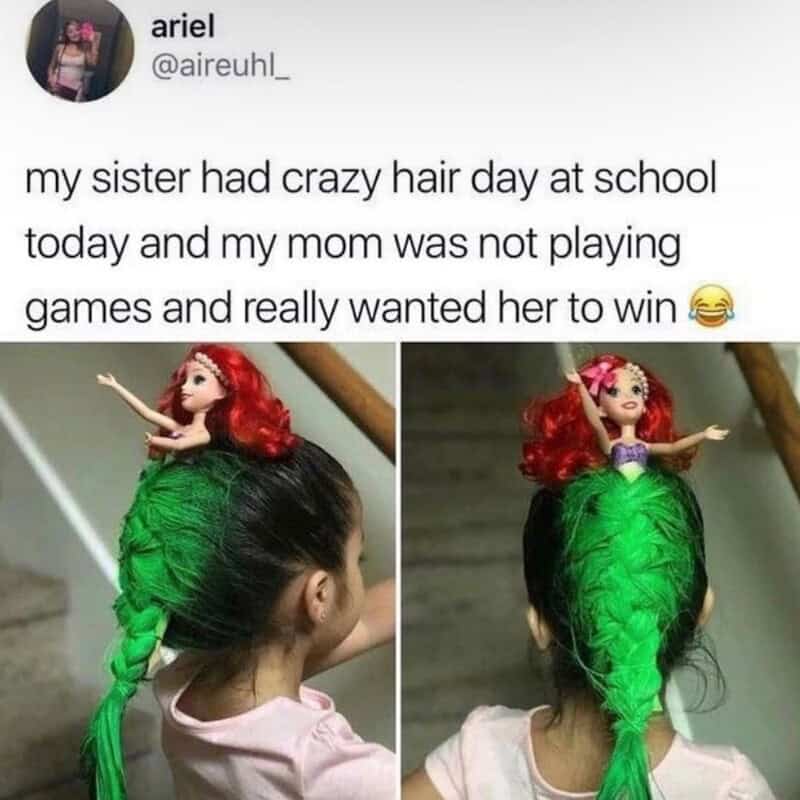 Doll with red hair and green braid on a girl's head, humorous hair day.