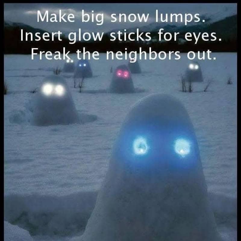 Snow lumps with glow sticks for eyes, creepy snow figures in a snowy landscape.