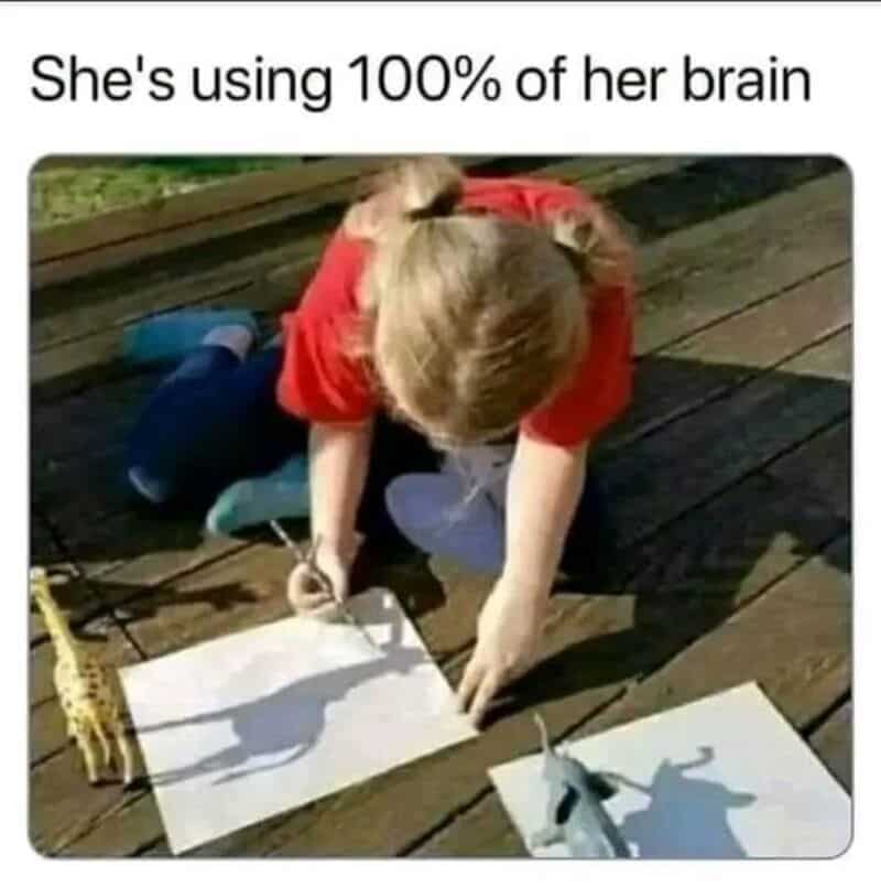 Child drawing on paper with animal shadow shadows, caption says she's using 100% of her brain.
