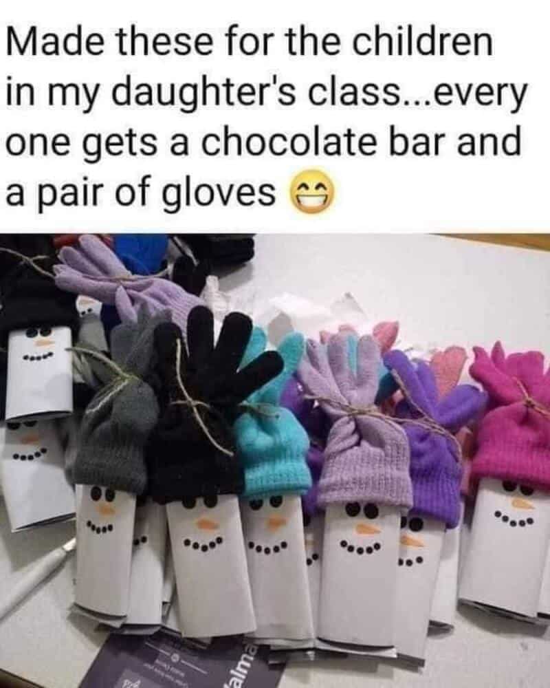 Children's craft project with paper towel rolls decorated as snowmen wearing gloves and hats.