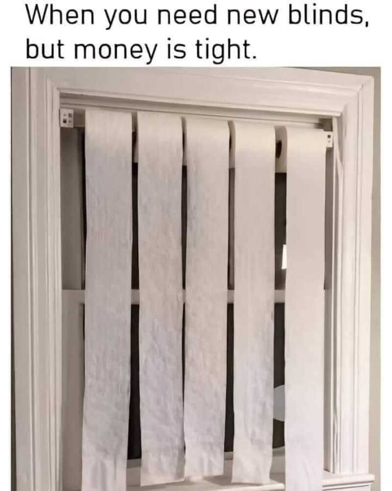 A makeshift blind made from white paper towels hanging on a door.
