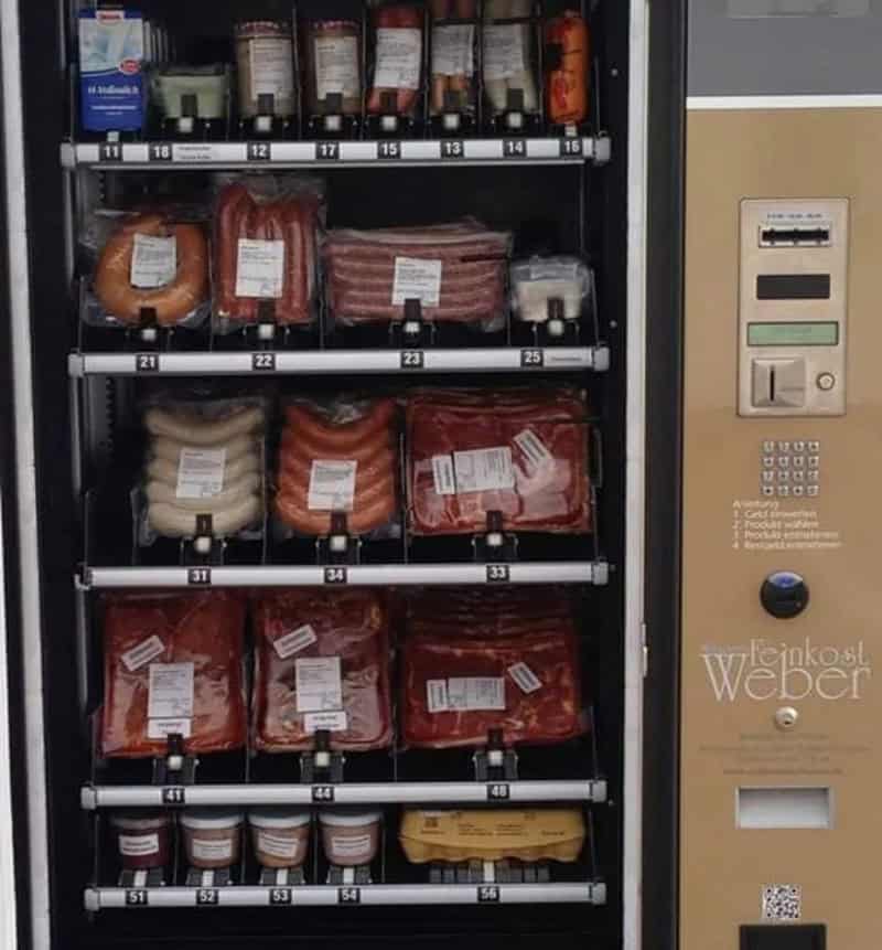 Vending machine with various meats and condiments, including sausages and sauces.