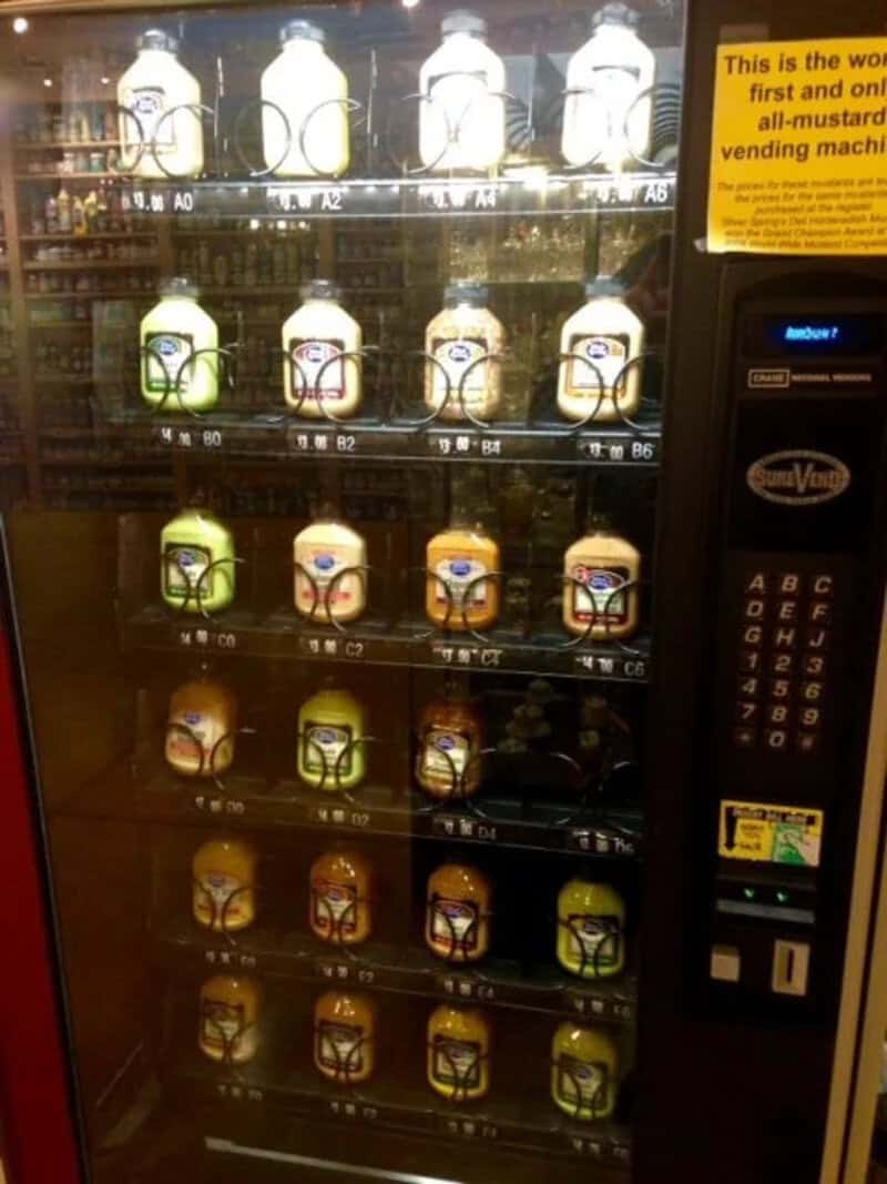 Vending machine with mustard bottles and a keypad for selection.