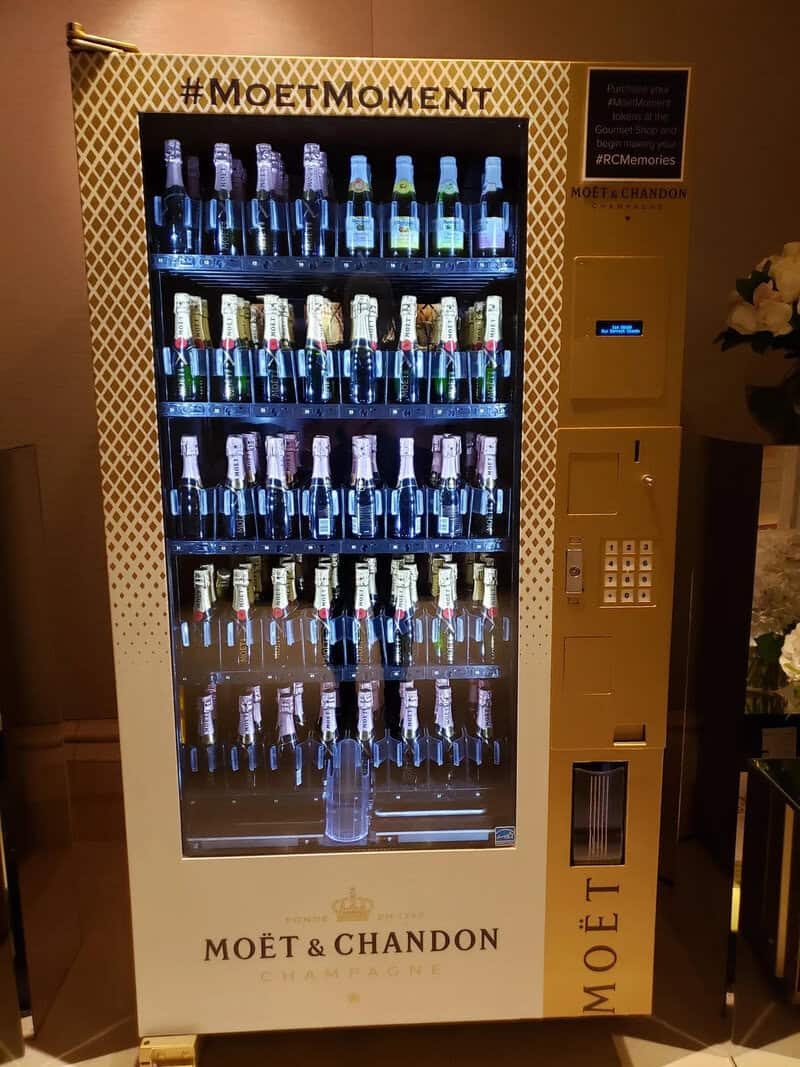 Vending machine with Moët & Chandon champagne bottles, illuminated display, hashtag #MOETMOMENT.