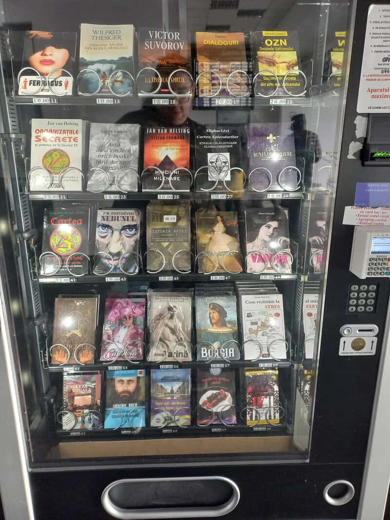 Vending machine with various books and magazines inside.