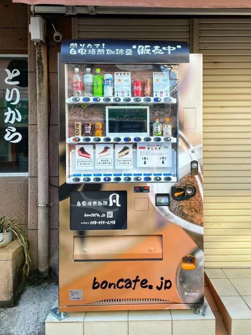 Vending machine with drinks and snacks, Japanese text, and a touchscreen.