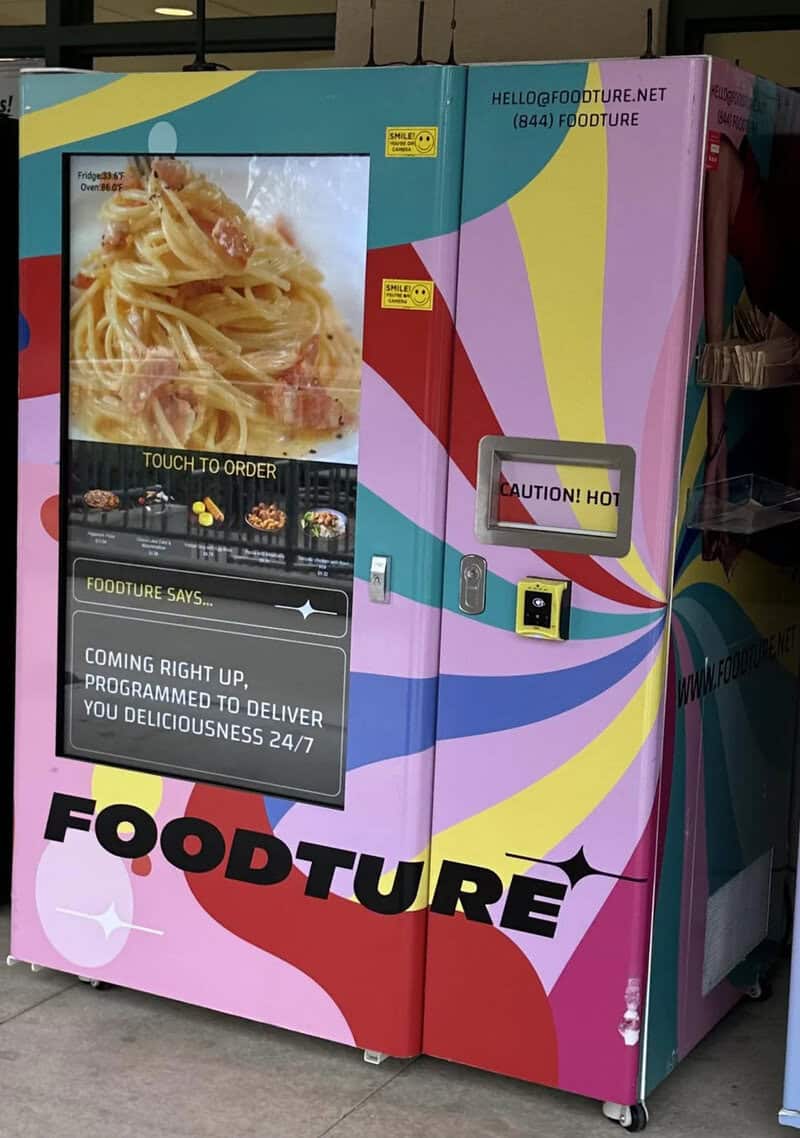Vending machine with food images and a touchscreen, labeled 'FOODTURE' and 'CAUTION! HOT'.