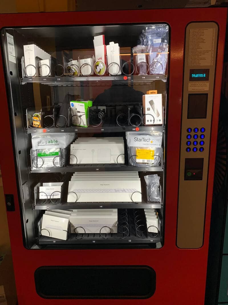 Vending machine with various electronic accessories and gadgets inside.
