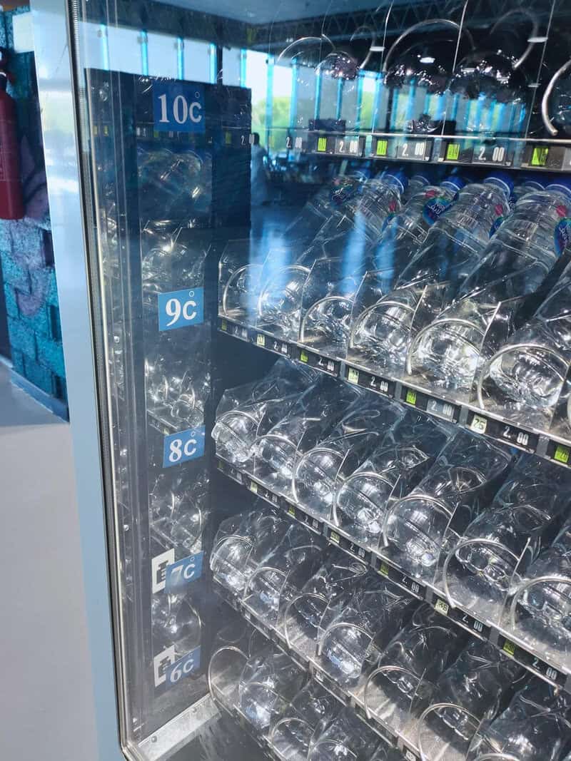 Vending machine with empty transparent bottles and price labels from 10c to 6c.