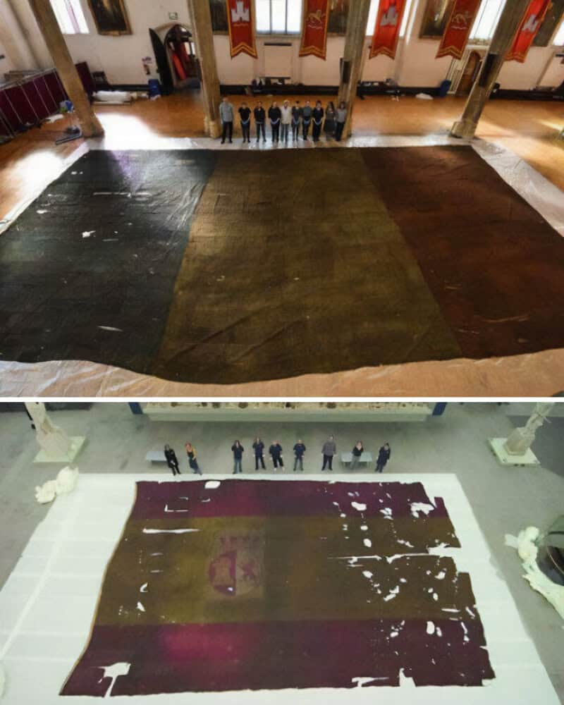 Large, worn-out flags on the floor of a hall, viewed from above.