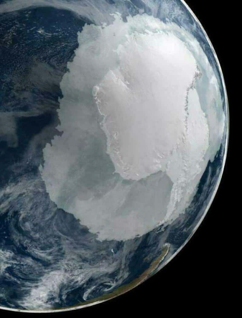 Earth with a large, white, cloud-covered landmass, possibly Antarctica.
