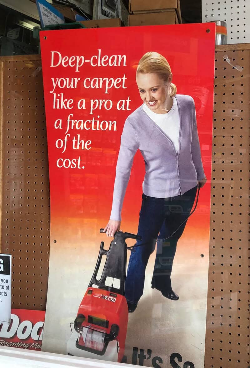 Woman with a vacuum cleaner on a red background with text about deep-cleaning carpets.