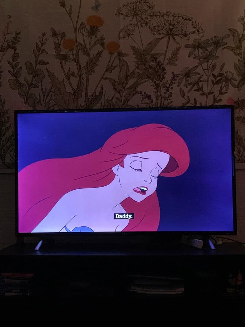 Animated girl with red hair says 'Daddy' on TV screen.