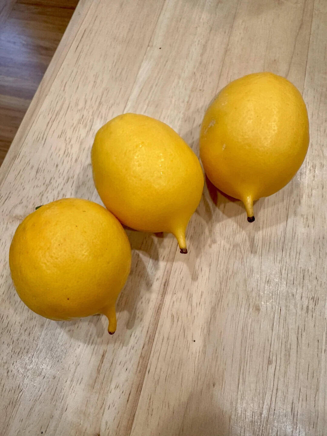 Three yellow lemons on a wooden table with a 'mildly interesting' post title.