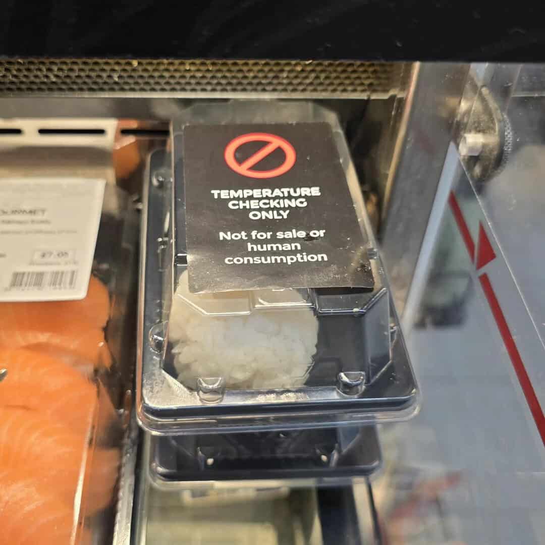 Temperature checking device with a warning sign for human consumption only.