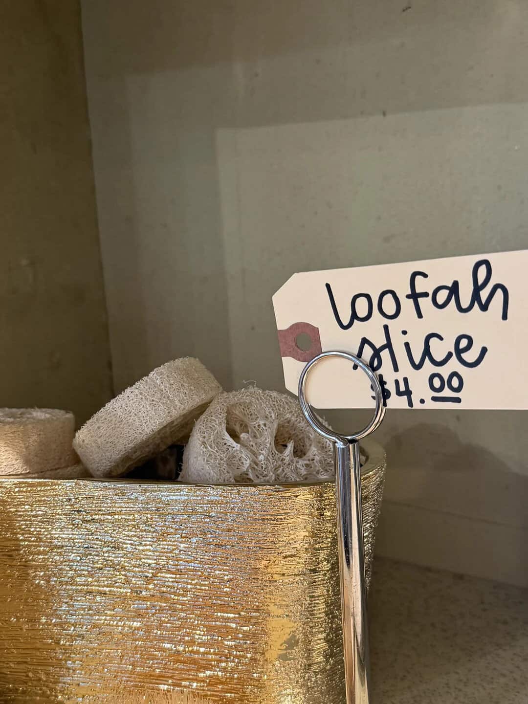 Loofah slices in a gold container with a 'Loofah Mice $4.00' sign.