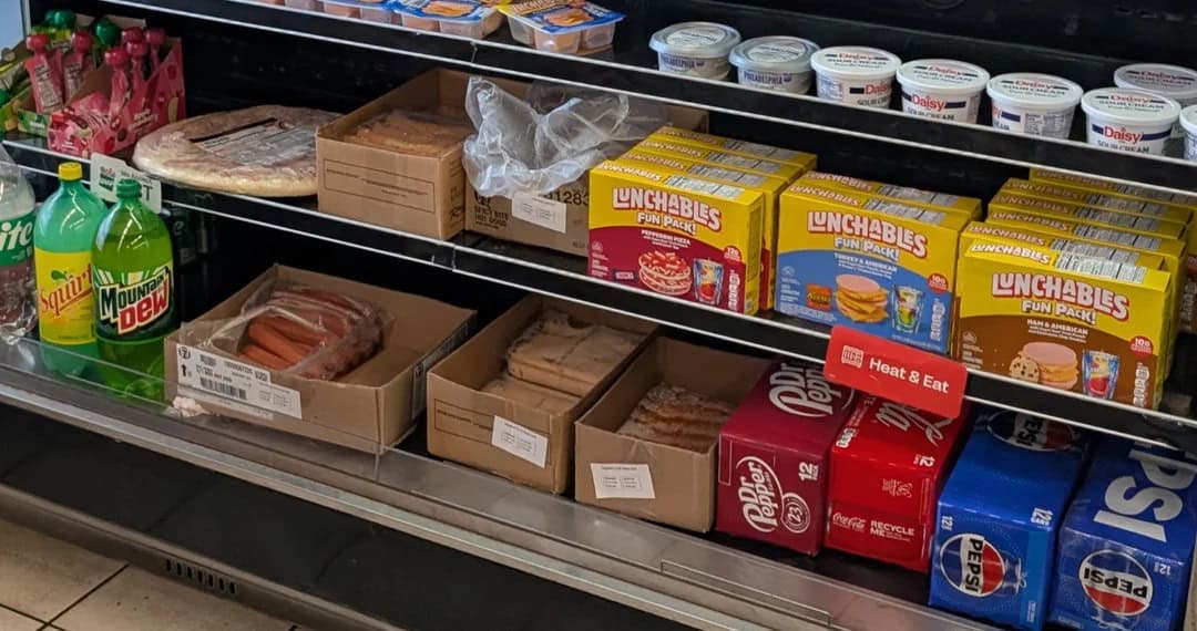 Snack aisle with Unchables, soda, and yogurt on shelves.