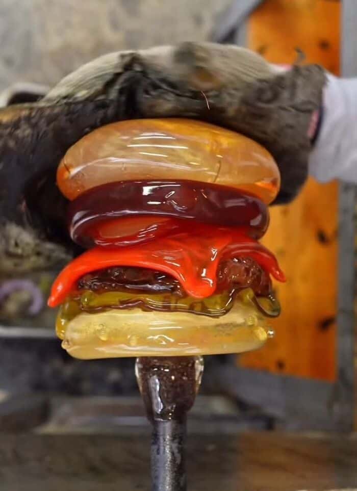 Colorful glass food sculptures stacked like a burger.