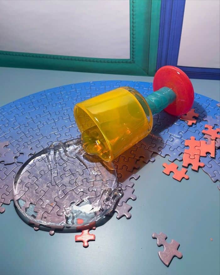 Colorful plastic toy with spilled water on puzzle pieces.