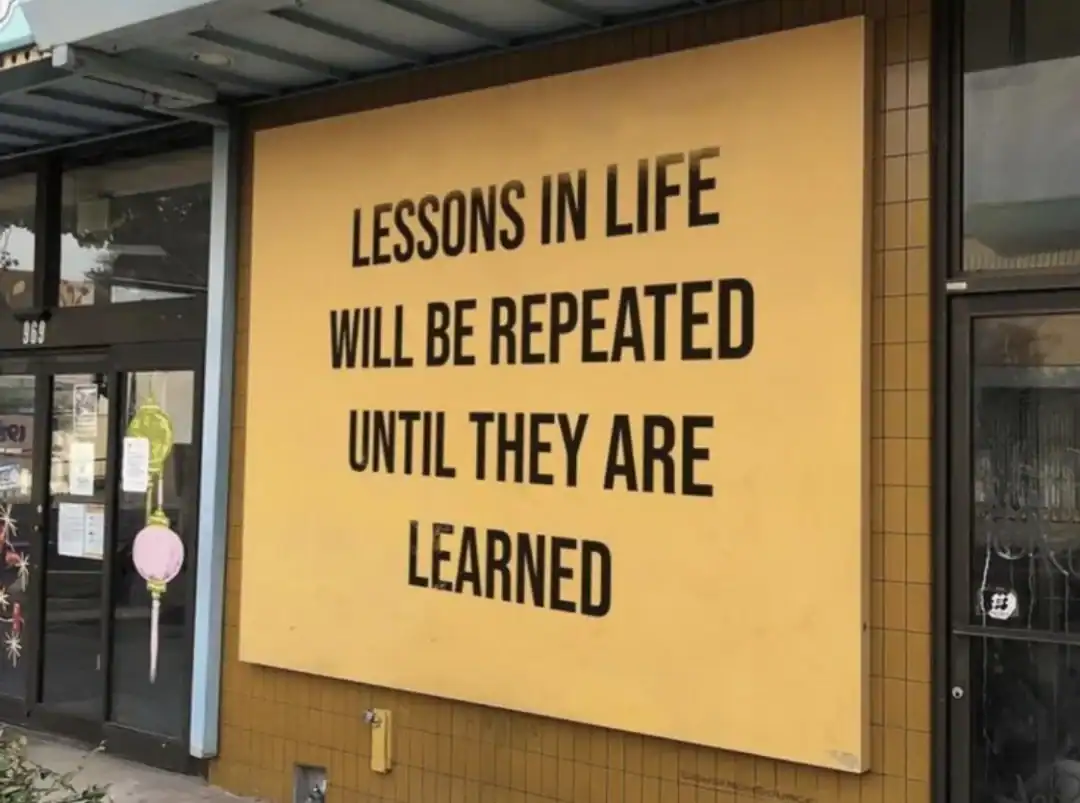 Lessons in life will be repeated until they are learned sign outside a building.