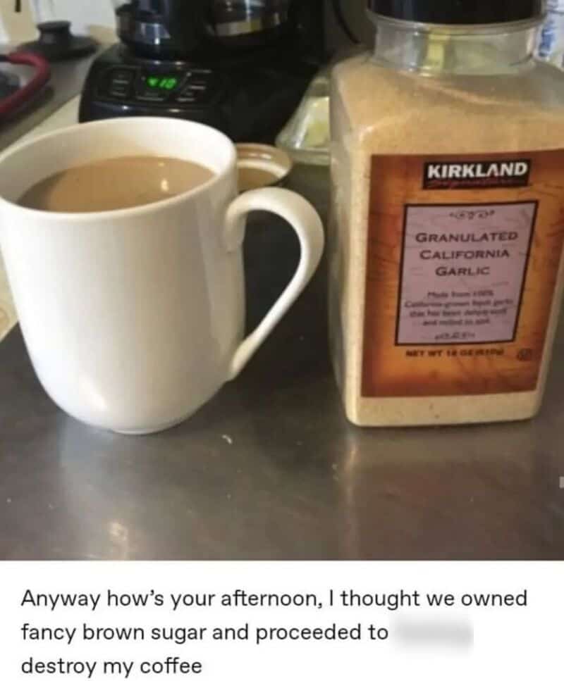 Coffee mug and garlic powder on a kitchen counter.
