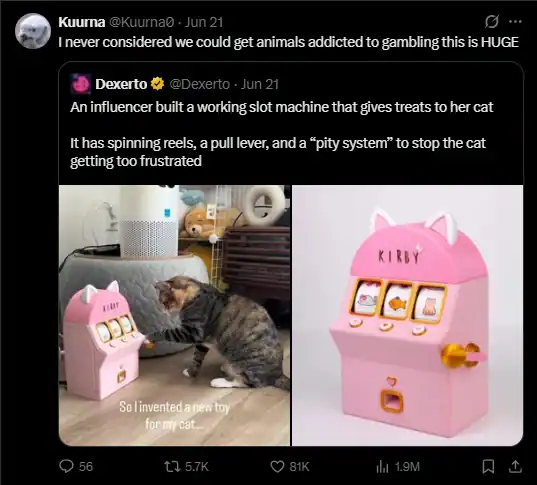 Photo of a cat playing with a pink toy slot machine labeled 'KIRBY' in a room.