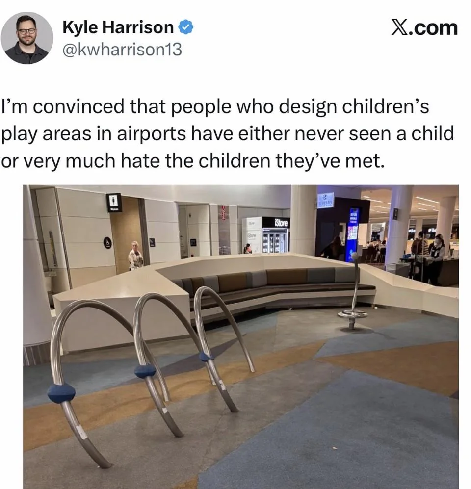 Empty airport children's play area with curved bench and metal climbing structures.