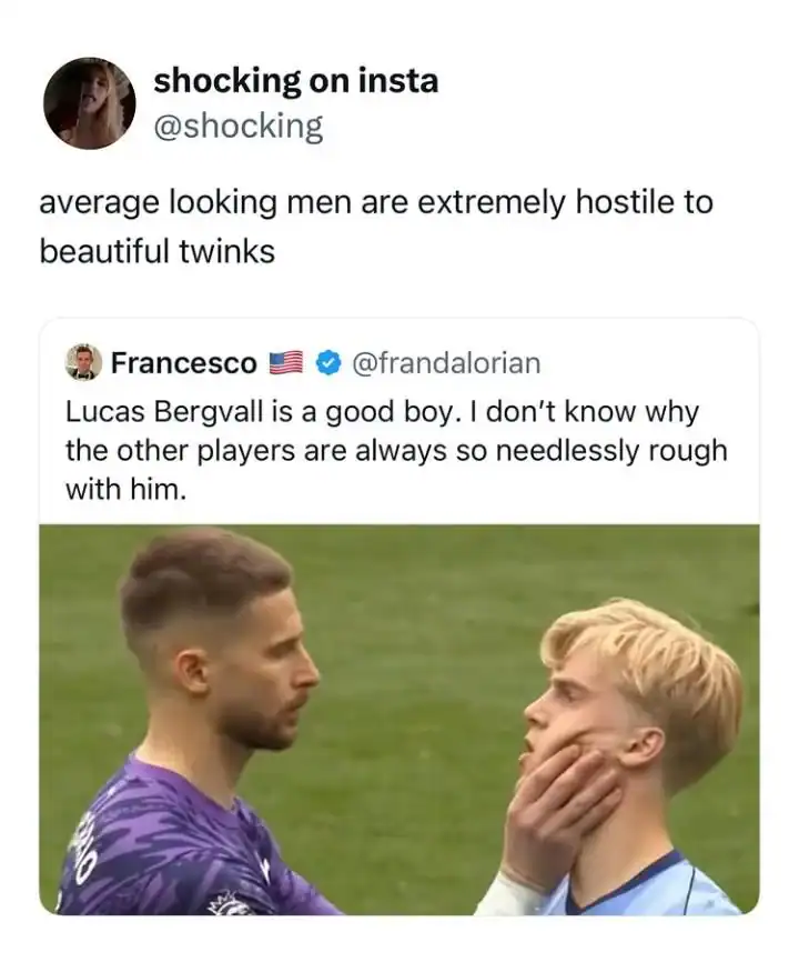 Two men, one with dark hair and beard, the other with blond hair, face each other outdoors.