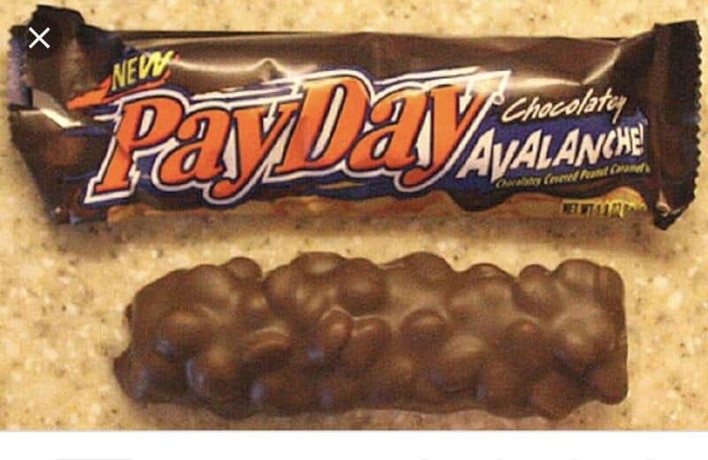 PayDay Avalanche chocolate bar with peanuts, on a beige surface.
