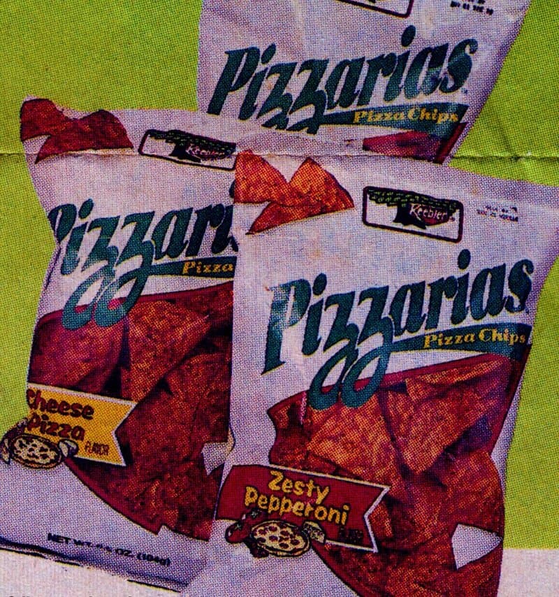 Three bags of Pizzarias Pizza Chips Zesty Pepperoni on a green surface.