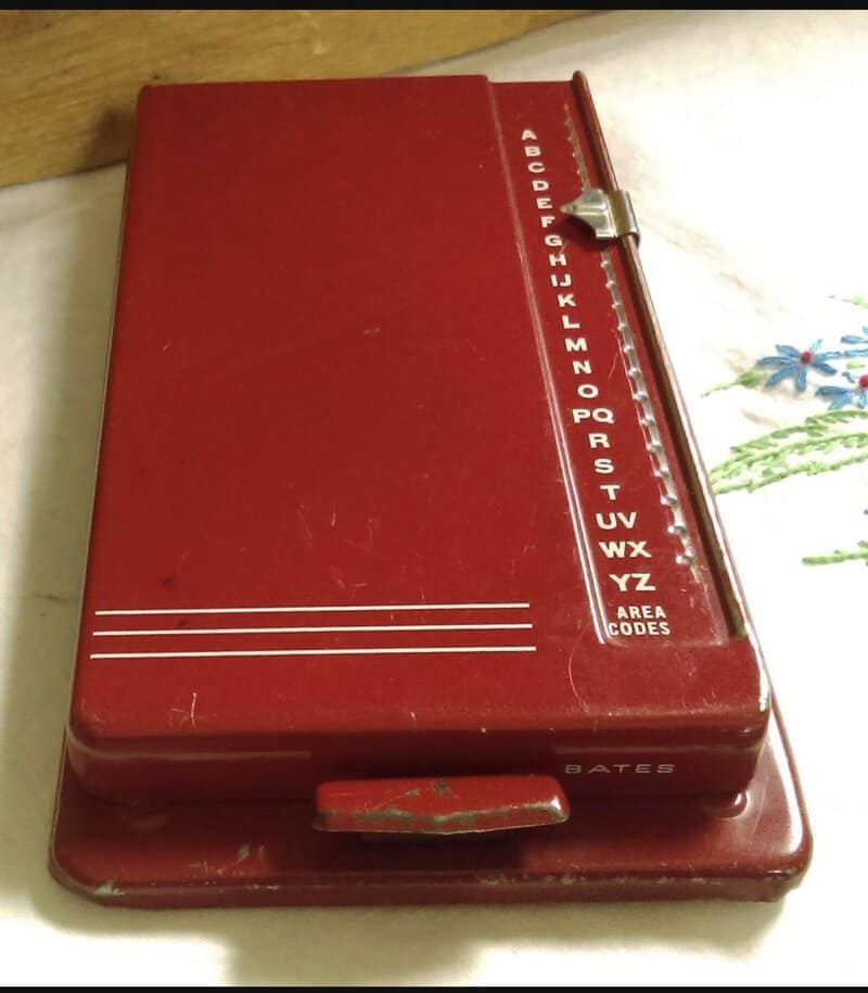 Red vintage BATES household code book with alphabet and area codes.