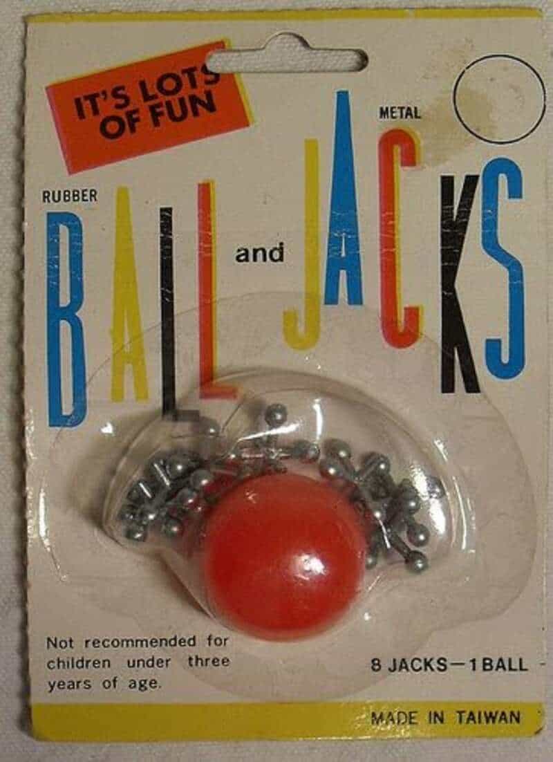 Vintage rubber ball and metal jacks toy set in packaging.