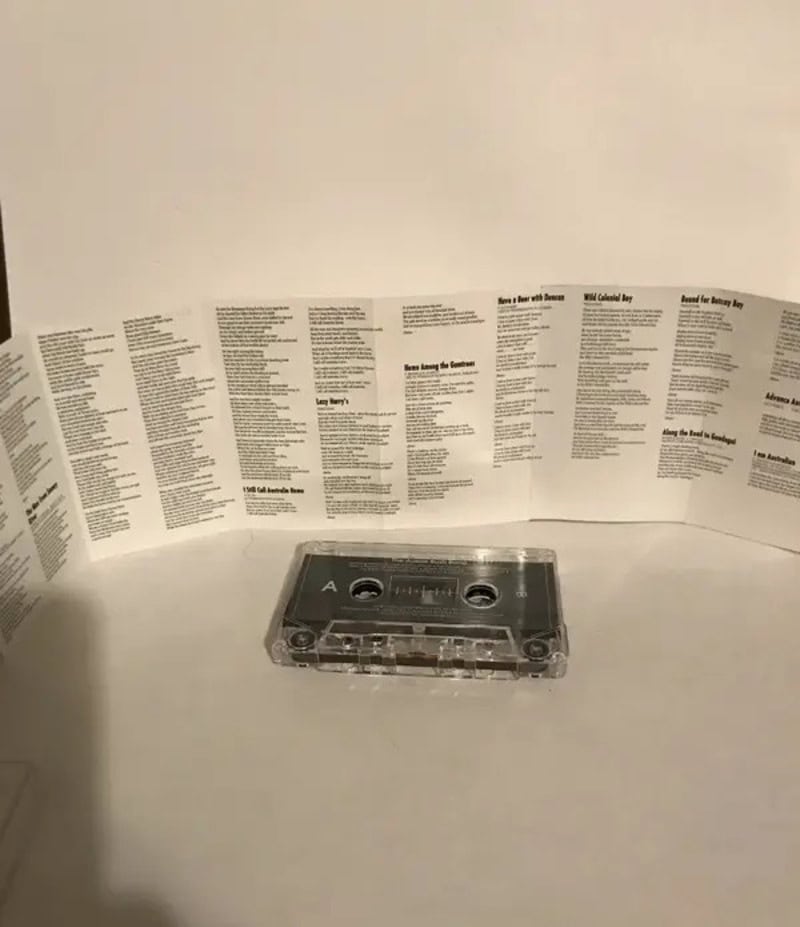 Cassette tape with paper insert and instructions or song list.
