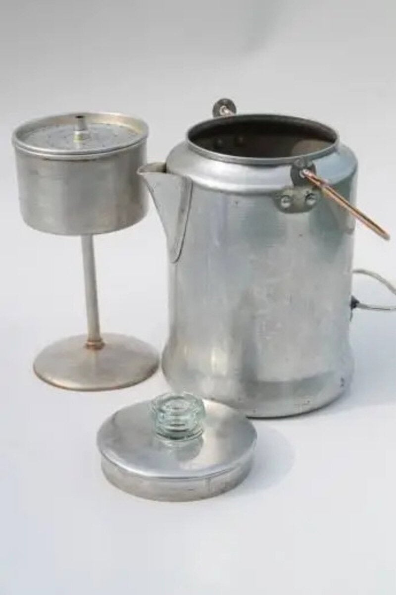 Vintage metal coffee percolator with a candle warmer and lid.
