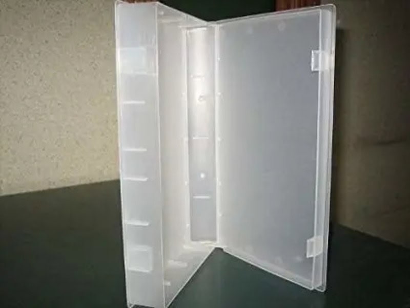 Empty plastic storage box with open lid on a table.