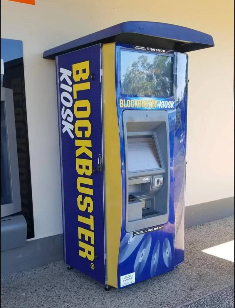 Blockbuster Kiosk at a store, blue and yellow colors, touchscreen interface.