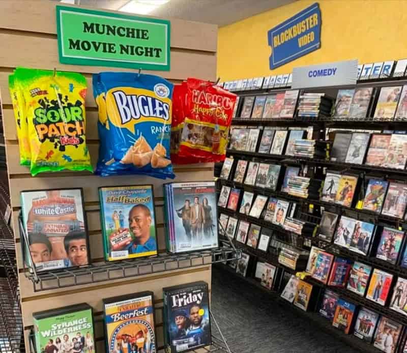 DVDs and snacks in a video store with a 'Munchie Movie Night' sign.