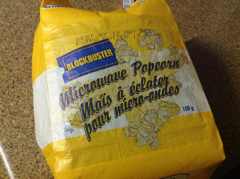Vintage Blockbuster microwave popcorn bag with yellow packaging and cartoon characters.