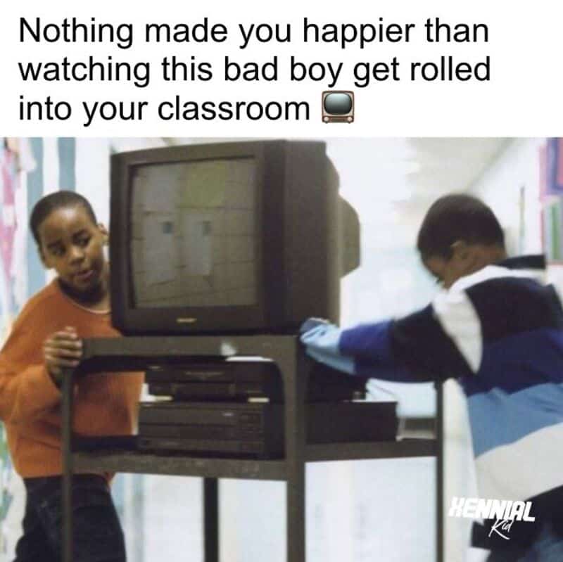 Kids watching a boy get rolled into the classroom with a TV and VCR.