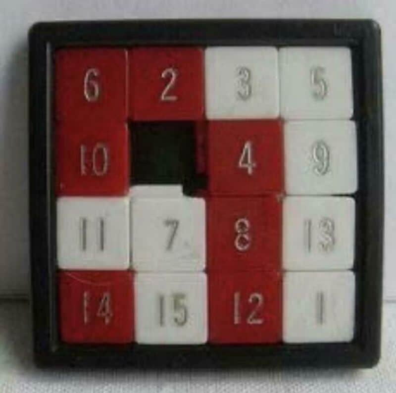 Vintage 80s puzzle game with numbered red and white tiles in a black frame.