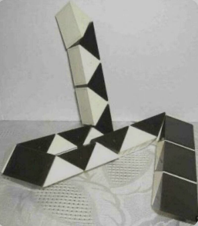 Stacked black and white geometric blocks forming an abstract shape.