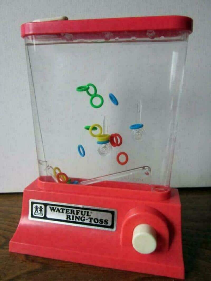 Waterful ring-toss game with colorful rings and a red base.