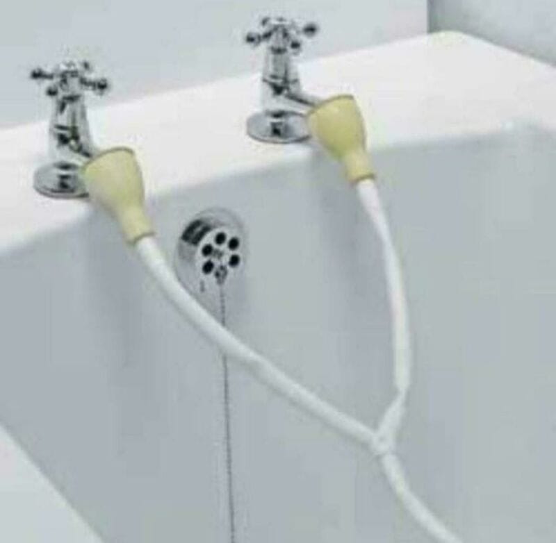 Two sinks with a shared shower head between them, resembling a humorous setup.