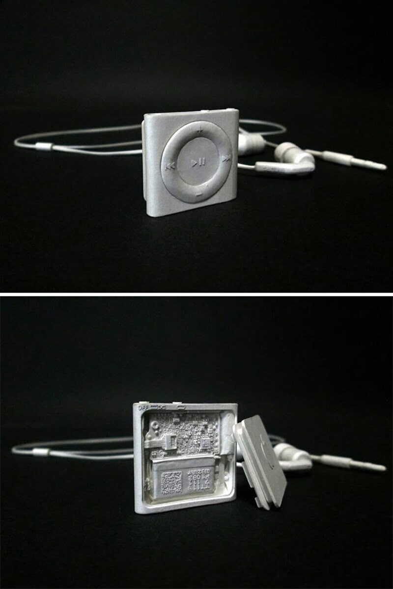 White iPod Shuffle with earphones on a black background.