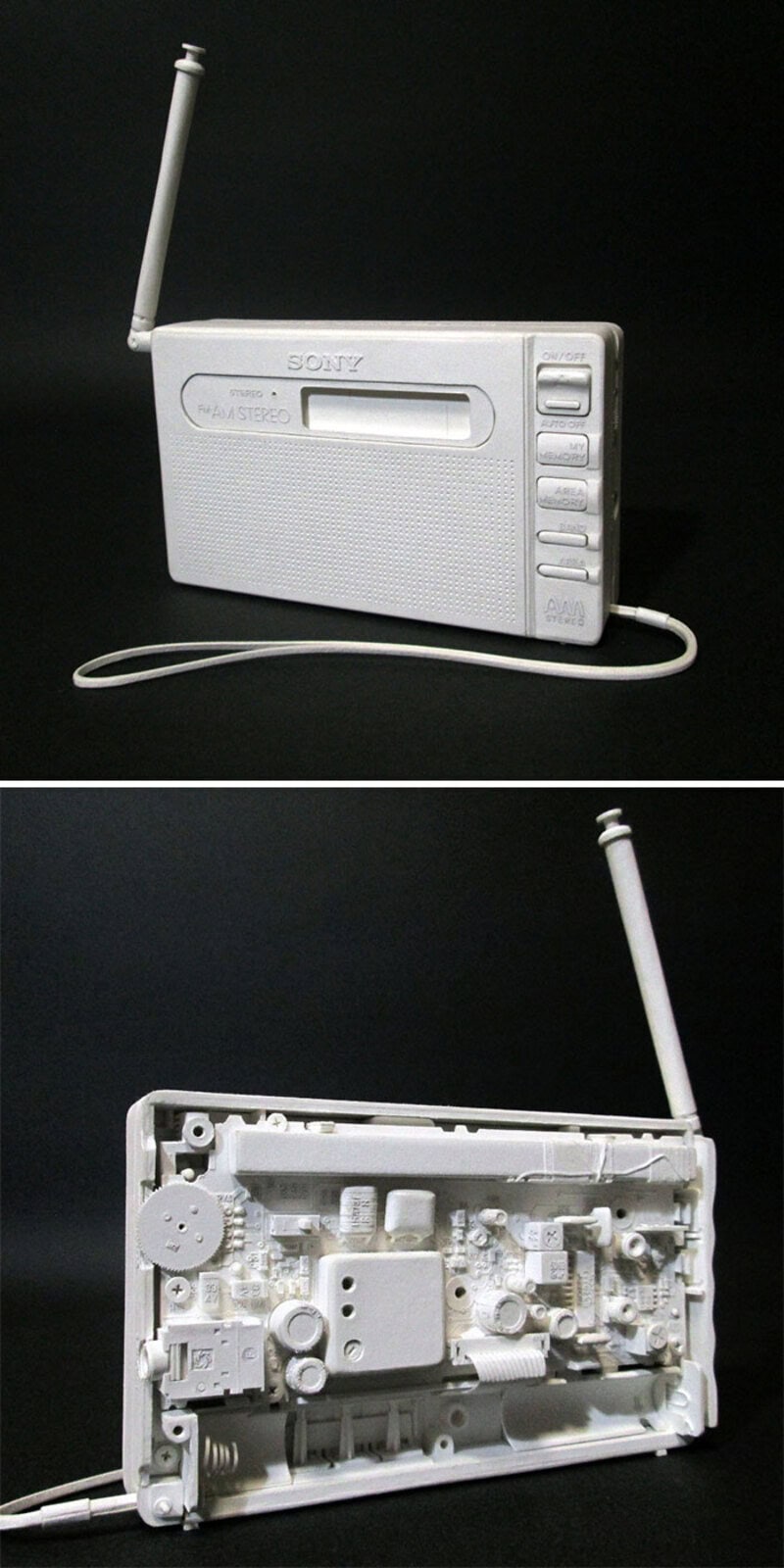 White portable radio with antenna, front and back views, part of paper sculpture.