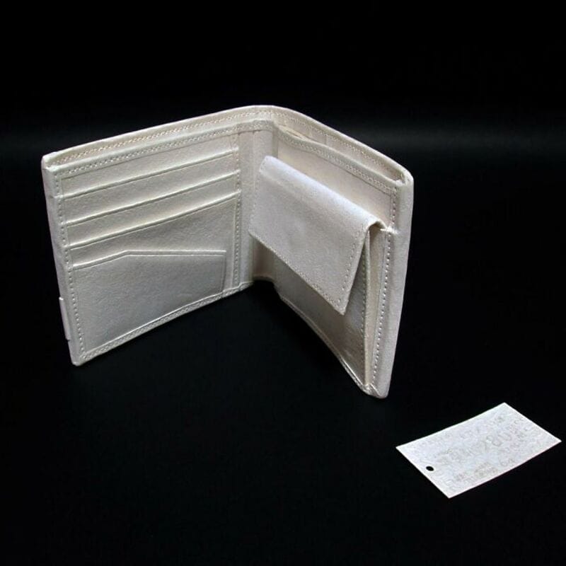 White wallet with card slots and a pocket, open on a black background.