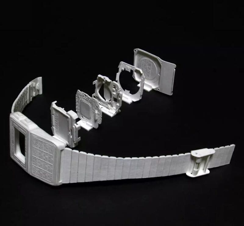White paper sculptures of retro electronics parts on black background.