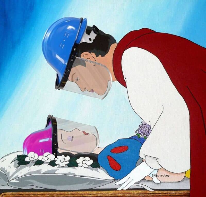 Person in protective gear with two glass containers over a body, flowers and a blue object nearby.